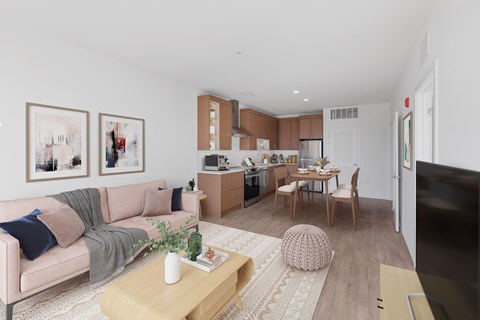 A modern living room with a pink sofa and a coffee table.