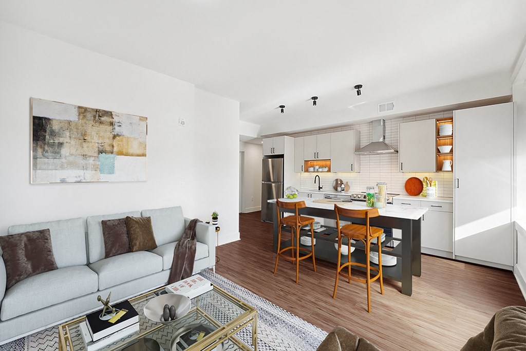 a living room with a couch and a kitchen with a table and chairs