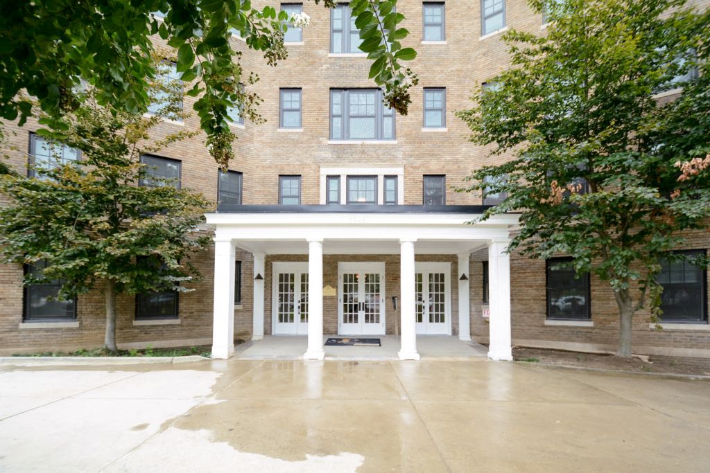 a large brick building with white pillars in front of it