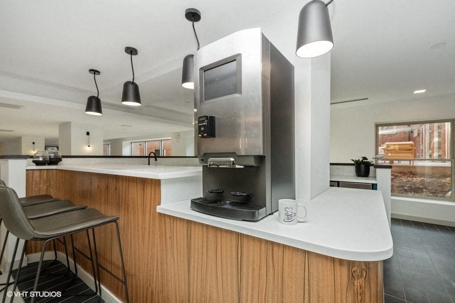 a kitchen with a stove top oven next to a microwave at Carver and Slowe Apartments, Washington