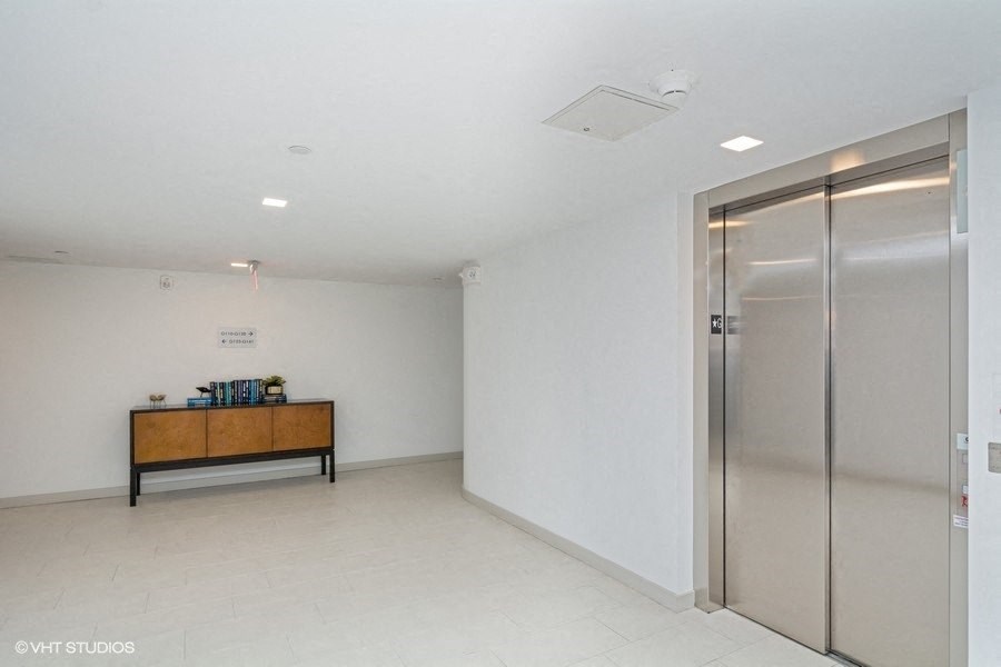 a room with a glass door and a wooden table with a plant on it at Carver and Slowe Apartments, Washington, 20001