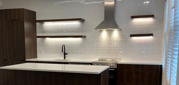 a kitchen with a stove top oven and a sink