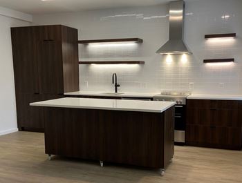 a kitchen with a large island with a white countertop