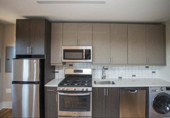 a kitchen with stainless steel appliances and wooden cabinets