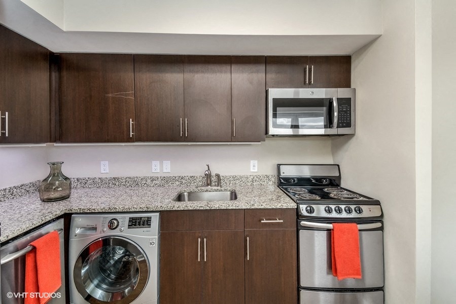a kitchen with wooden cabinets and stainless steel appliances