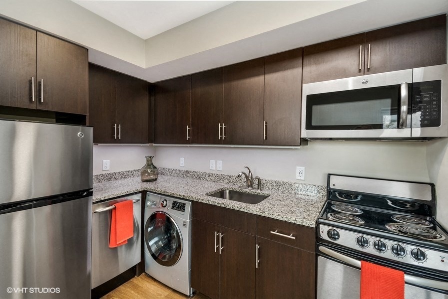 a kitchen with brown cabinets and a white stove top oven