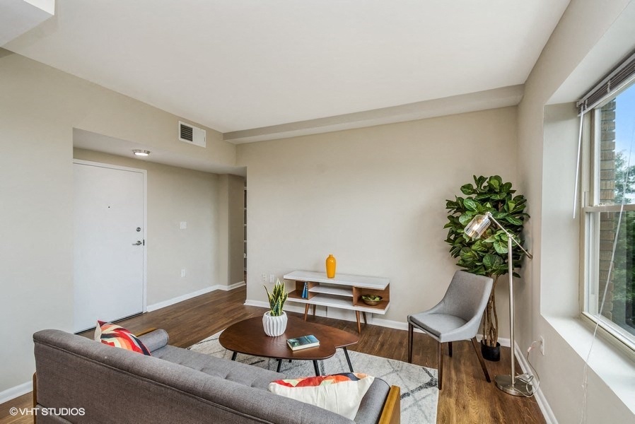 a living room with a couch and two chairs