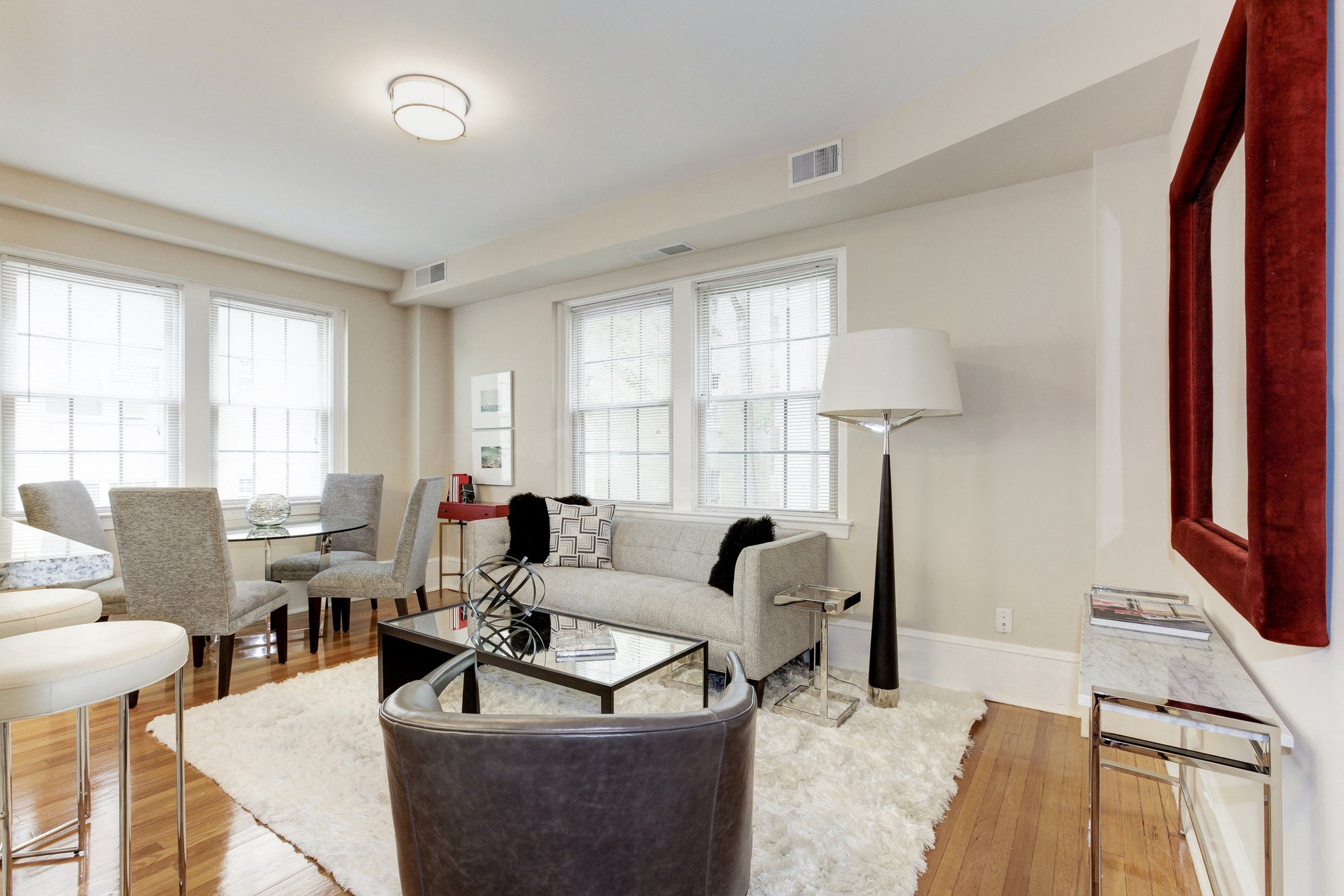 a living room with a couch and chairs and a table