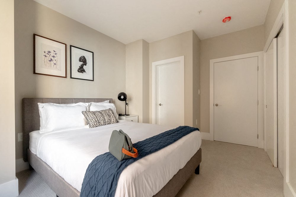 a bedroom with a bed and two doors