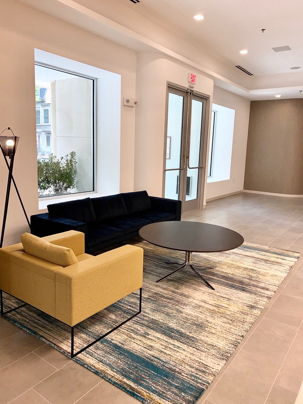 a living room with a yellow couch and a black coffee table at Carver and Slowe Apartments, Washington, 20001