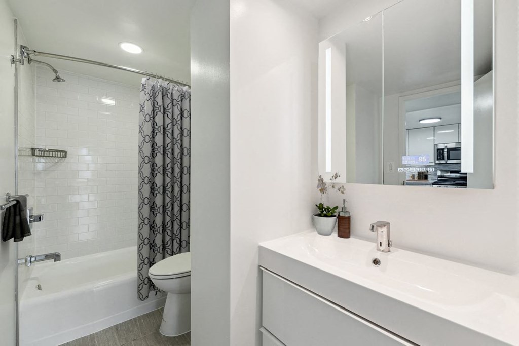 a bathroom with a sink and a shower and a toilet