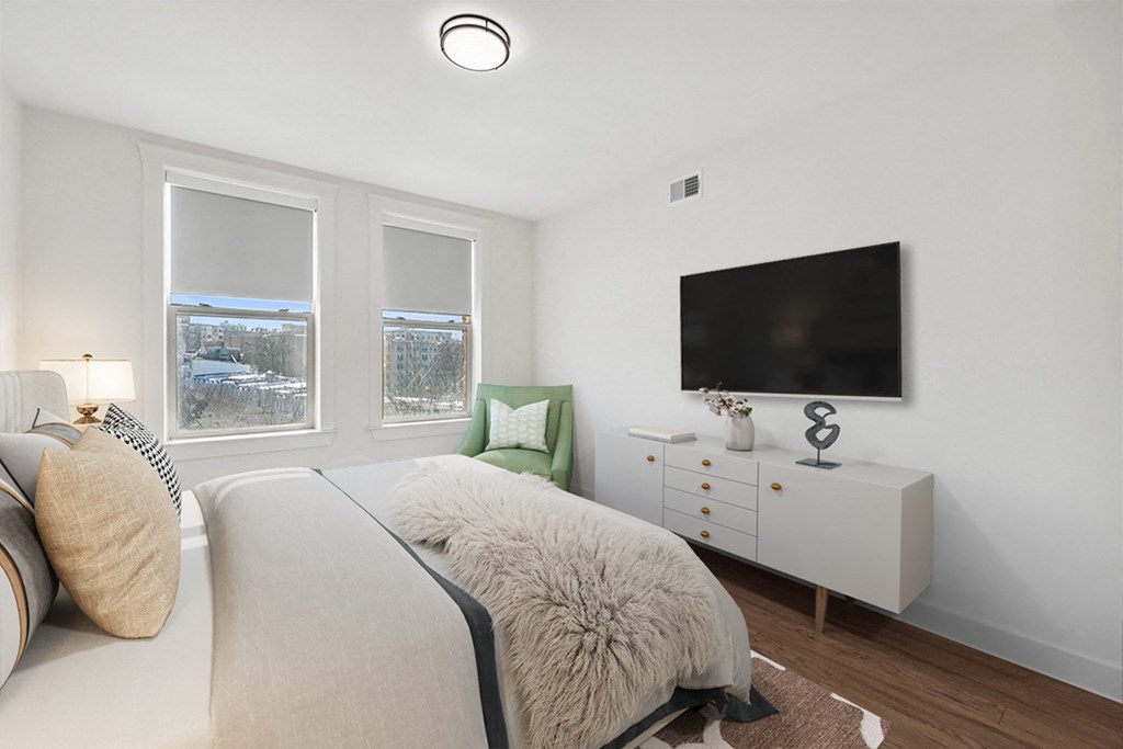 a bedroom with a large bed and a tv