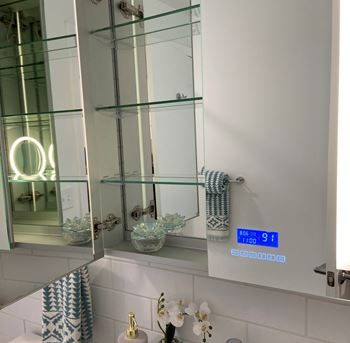 a bathroom with a large mirror and a sink with a blue and white checkered towel