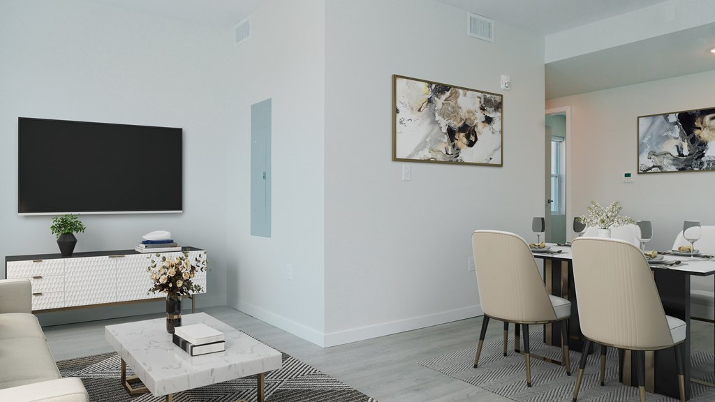 A modern living room with a flat screen TV, a coffee table, and a dining table with chairs.
