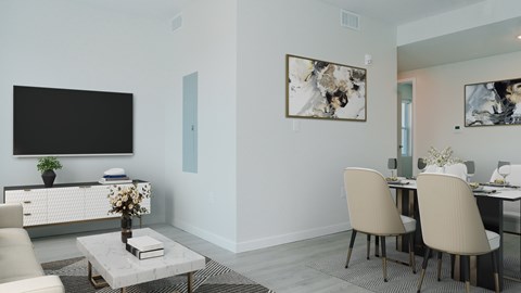 A modern living room with a flat screen TV, a coffee table, and a dining table with chairs.