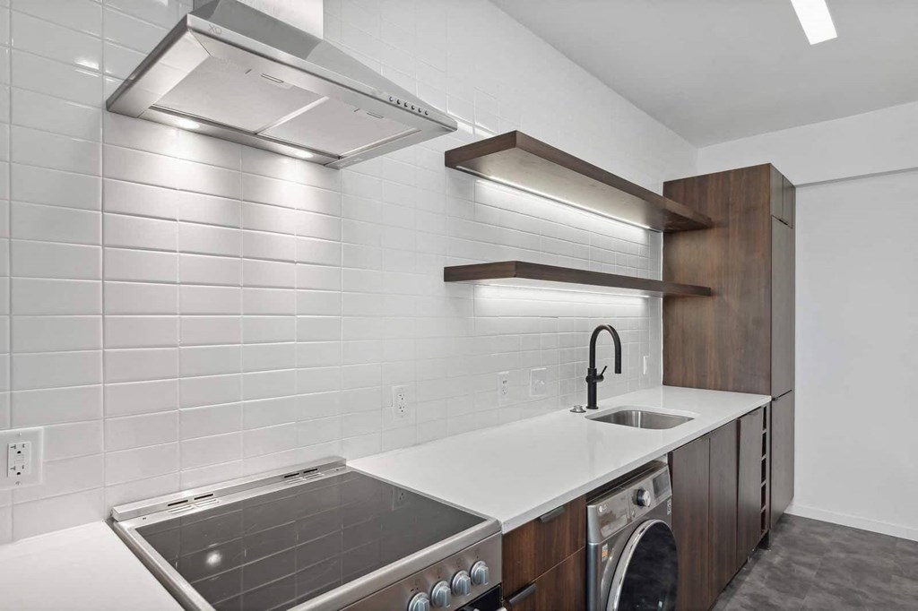 a kitchen with a stove top oven next to a sink