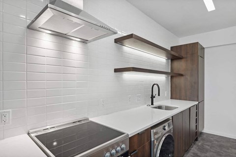a kitchen with a stove top oven next to a sink