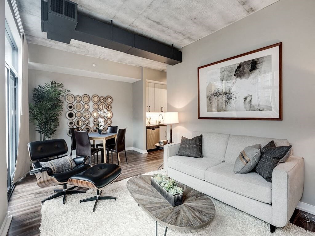 a living room with a couch and a chair and a table