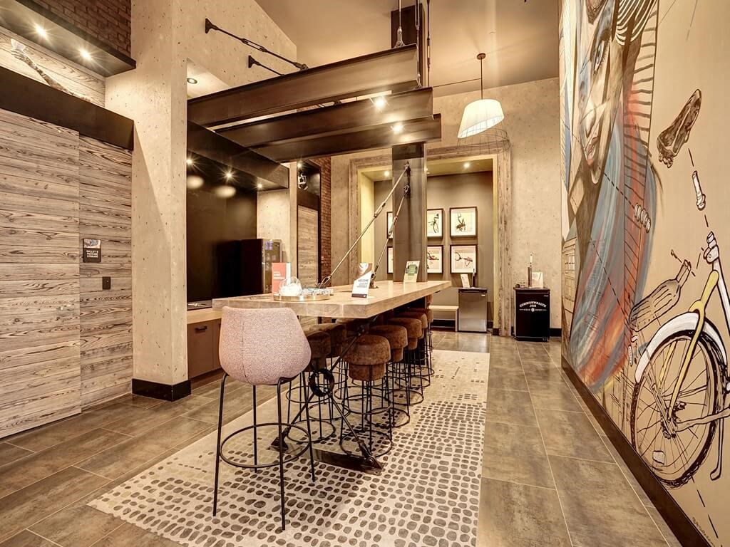 a bar with stools and a table in a lobby