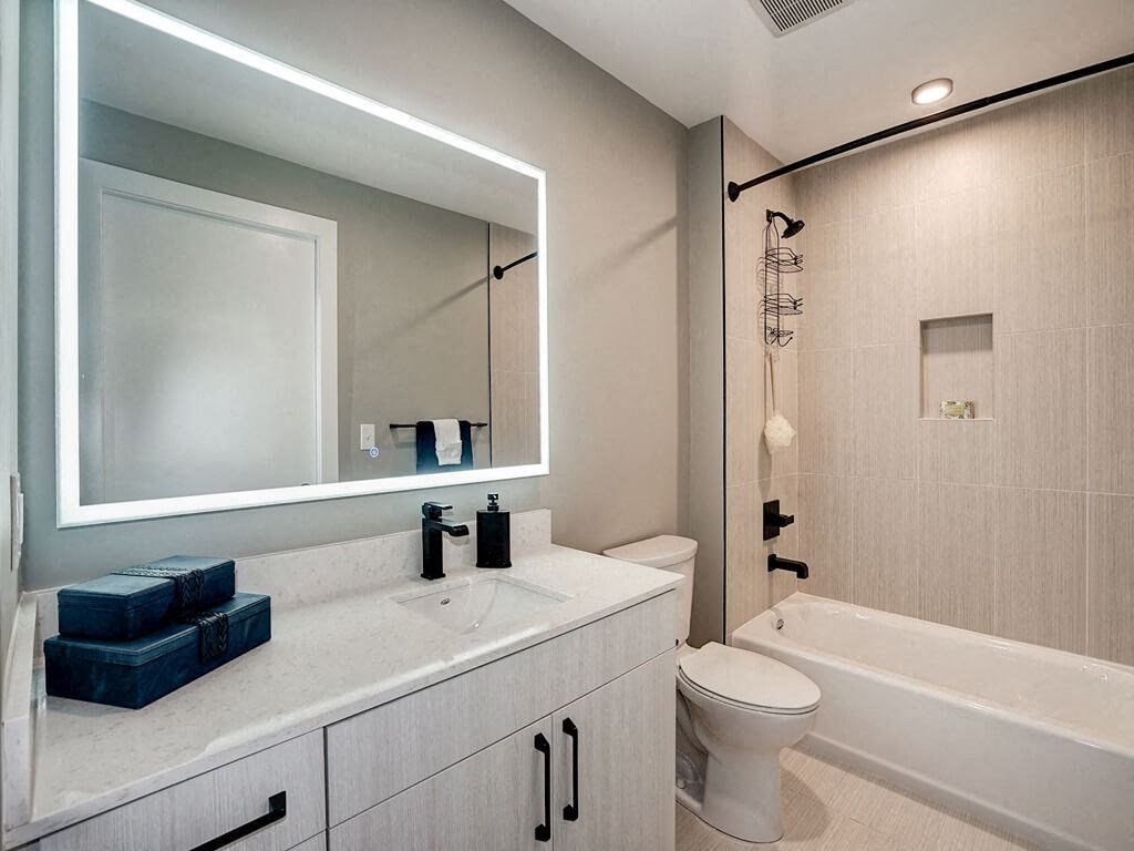 a bathroom with a toilet and a sink and a mirror
