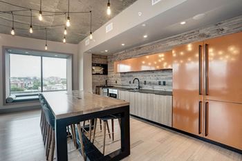 a large kitchen with a large island and stainless steel appliances at Coda on H Apartments, District of Columbia 20002