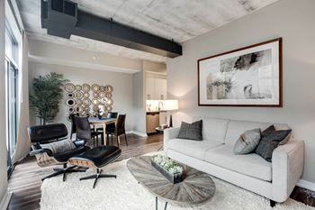 Living room with grey couch at Coda on H Apartments, Washington, 20002
