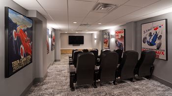 a room filled with black chairs and a flat screen tv