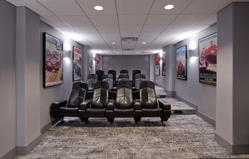 a room filled with lots of black leather chairs