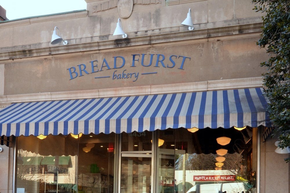 the front of a breadfruit bakery with a blue and white striped canopy at The Chesapeake Apartments, Washington 20008