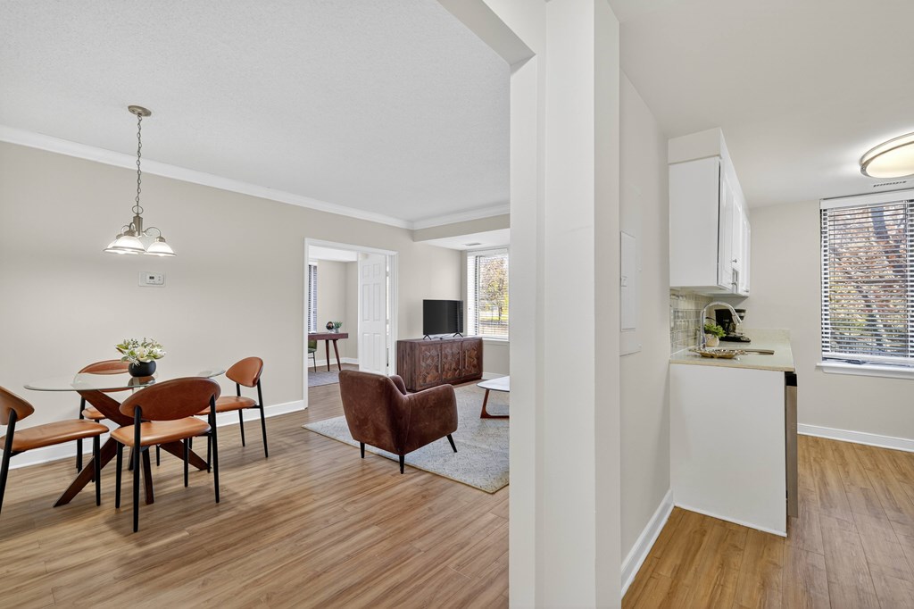 A living room with a dining table and chairs.
