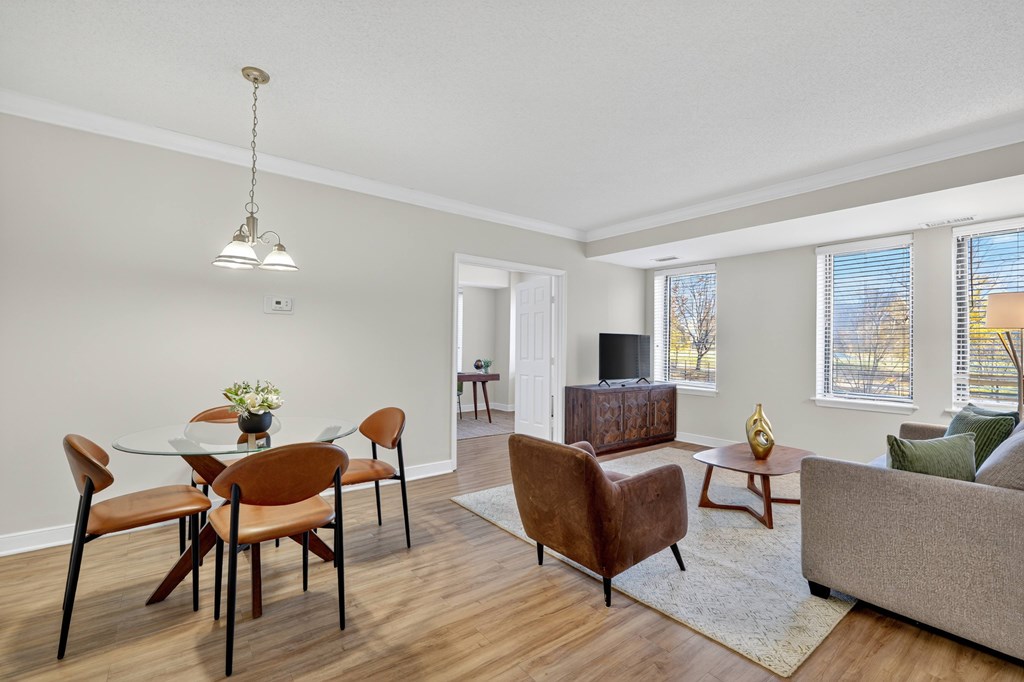 A living room with a dining table and chairs.