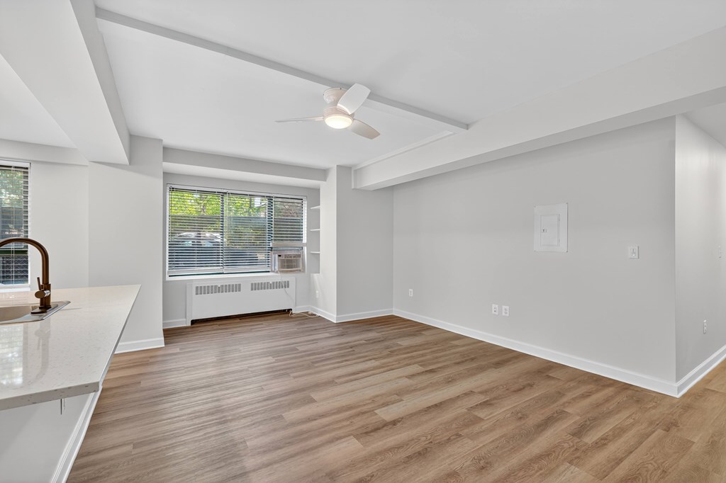 A room with a white ceiling and wooden flooring.