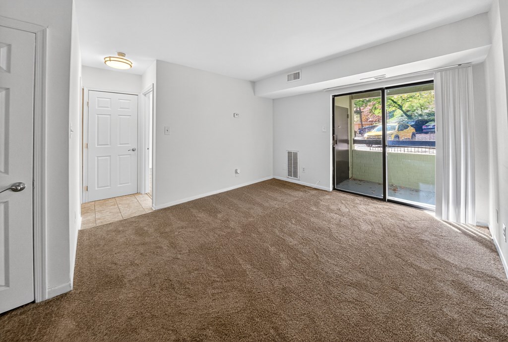 A room with brown carpet and white walls.