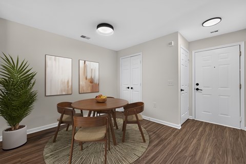 A dining room with a wooden table and chairs.