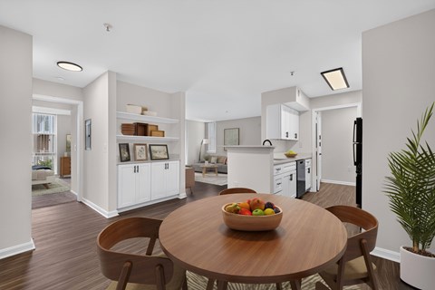 A modern kitchen with a wooden table and chairs.
