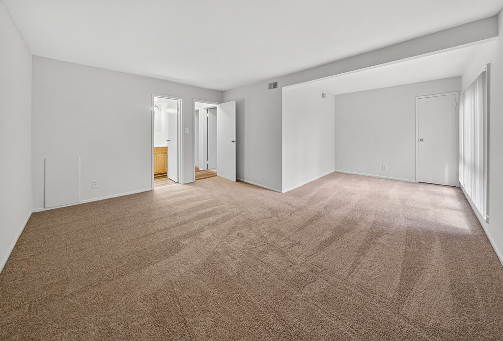 A room with carpeted floor and white walls.