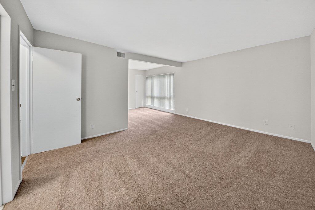A room with carpeted floor and white walls.