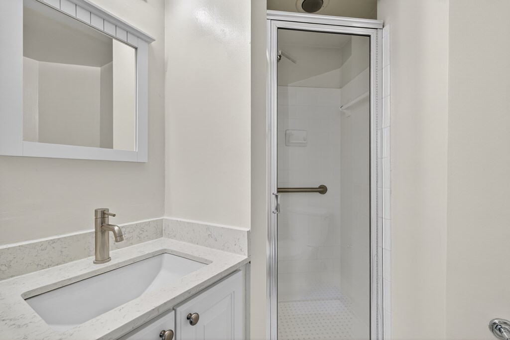 A white sink with a silver faucet in a bathroom.