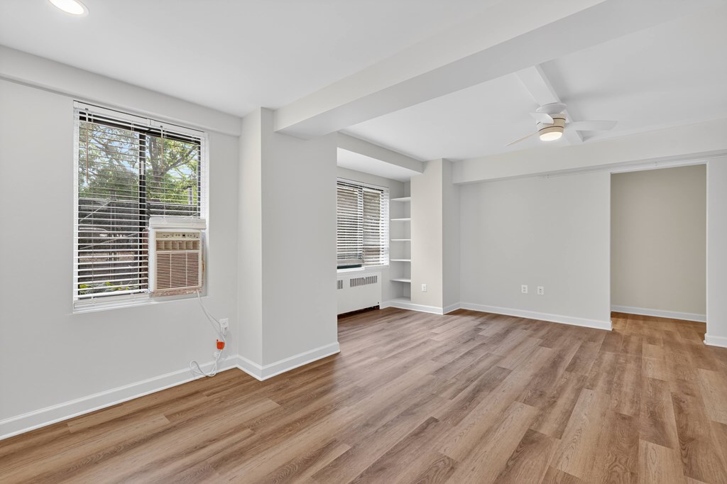 A room with wooden flooring and a ceiling fan.