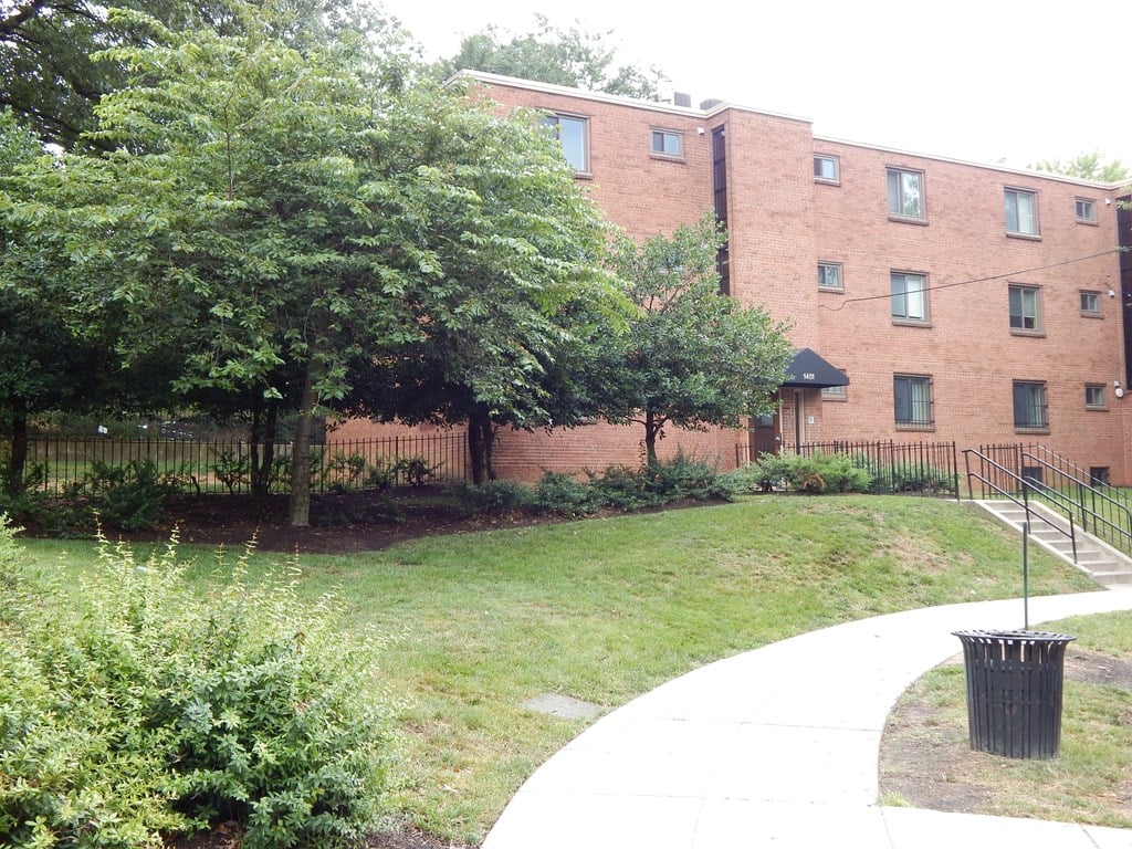 A brick building with a green lawn in front.