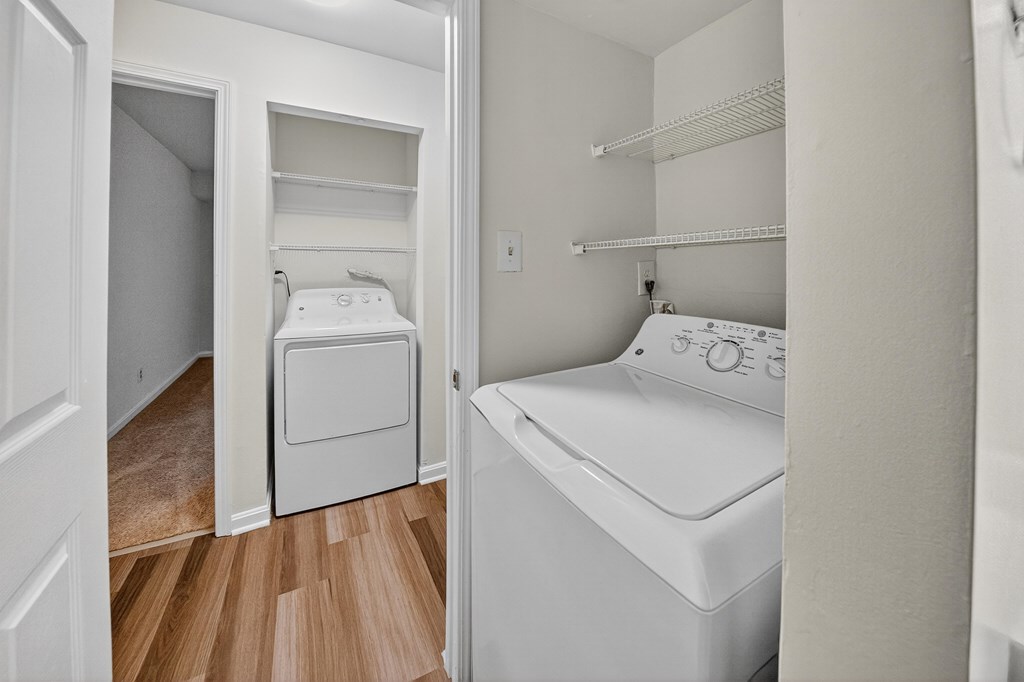 A small bedroom with a washer and dryer built into the cabinetry.