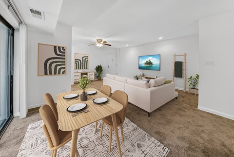 A modern dining room with a wooden table and chairs.