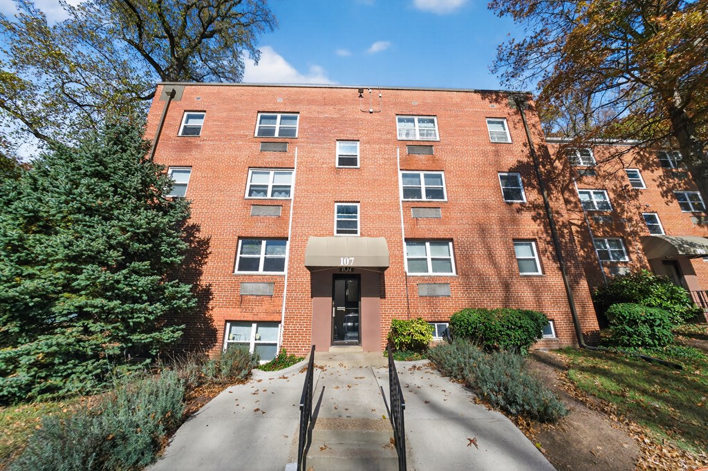 A red brick building with the number 1077 on the front.