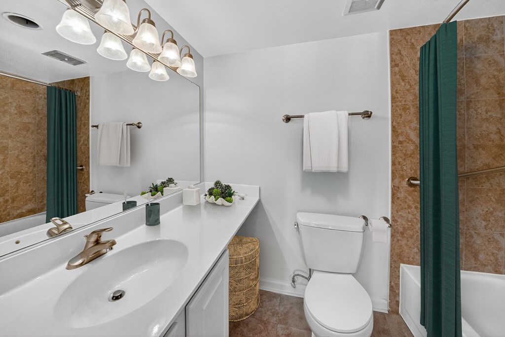 A bathroom with a white toilet and a white sink.