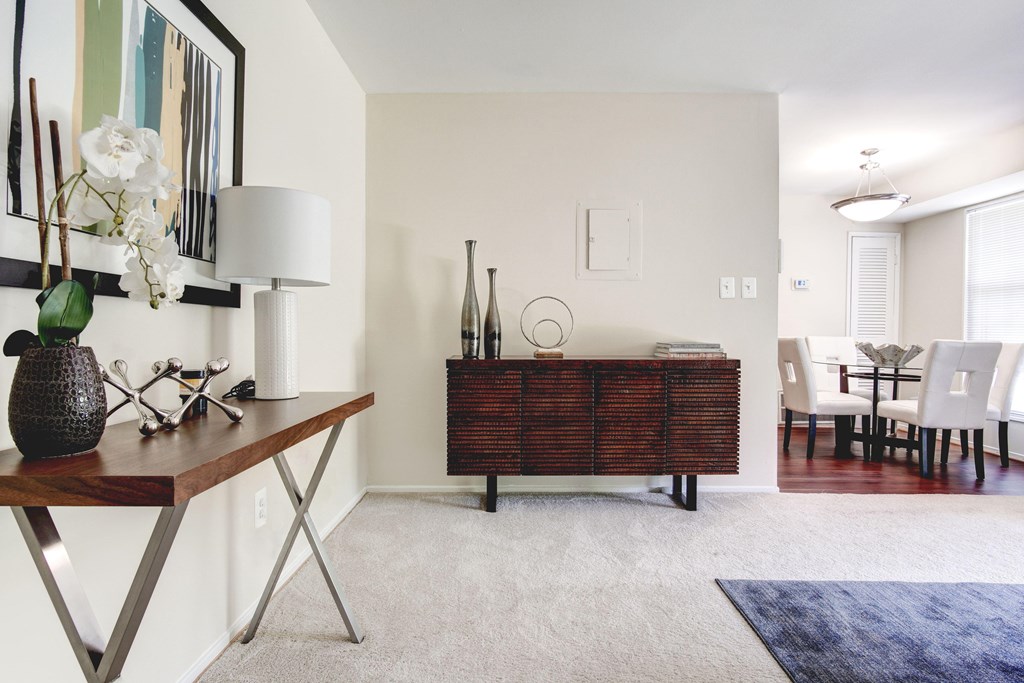 A room with a brown table and a white lamp.