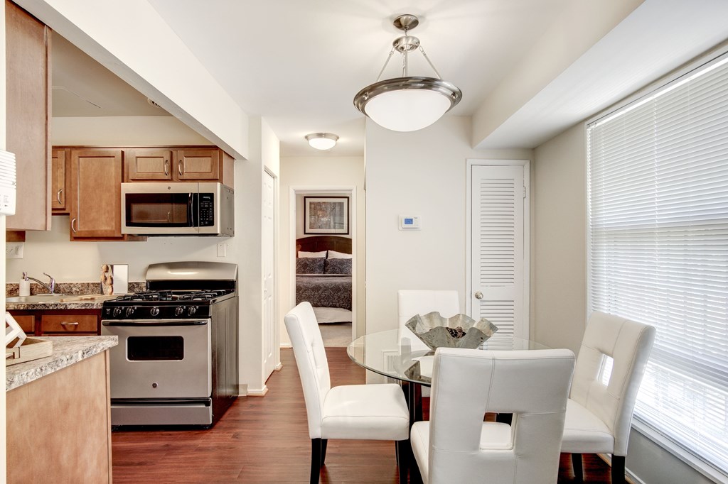 A modern kitchen with a dining table and chairs.