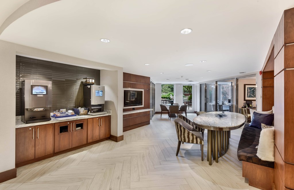 A modern kitchen with a breakfast bar and a dining area.