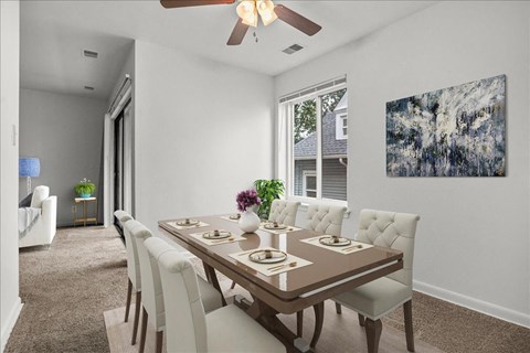 a dining room with a table and chairs and a ceiling fan