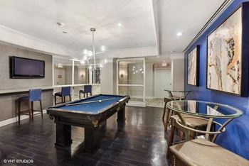 a game room with a pool table and a tv at The Saratoga Apartments, Washington, 20008