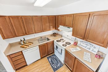 an aerial view of a kitchen with wooden cabinets and white appliances